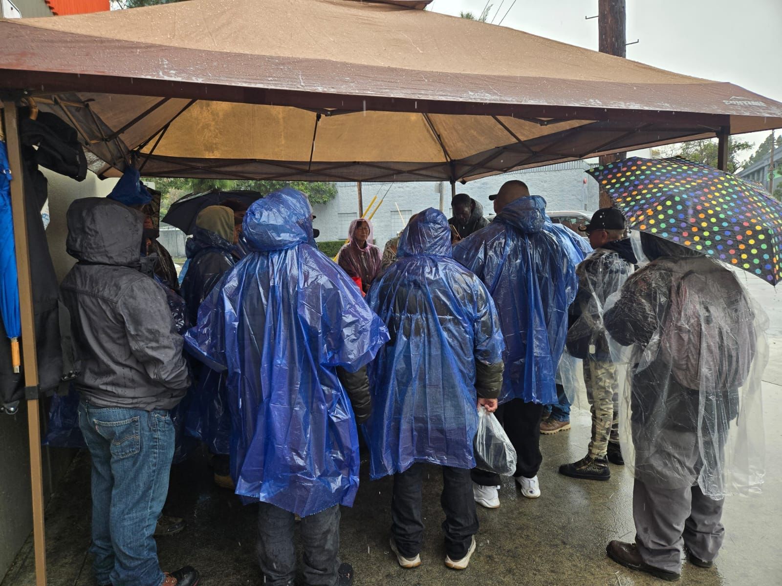 Worship in the rain under a tent